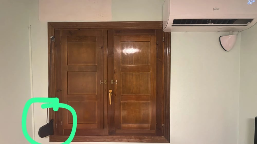 The strap box beside the window — this works the shutter